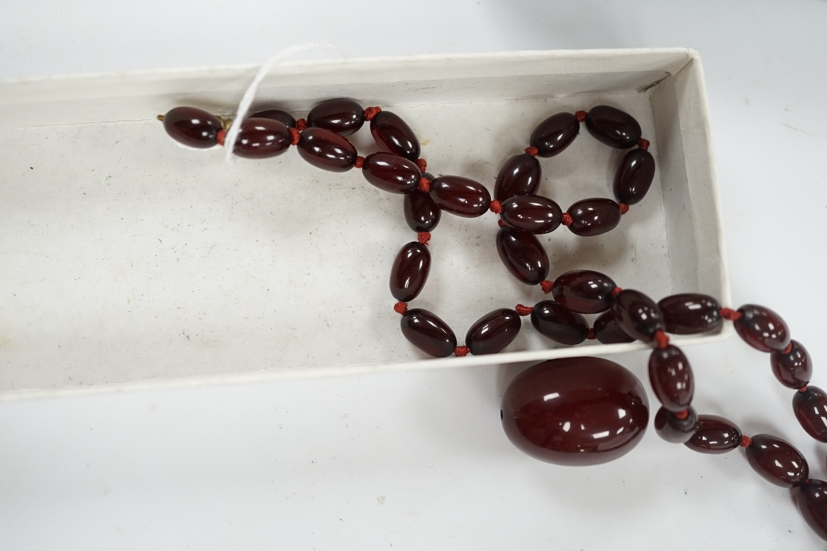 A single strand graduated simulated cherry amber bead necklace, gross weight 66 grams (string a.f.) Condition - poor to fair